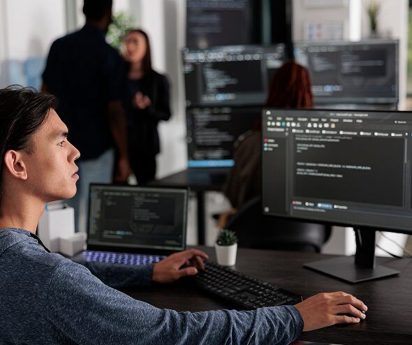 Developer working on website code at a workstation