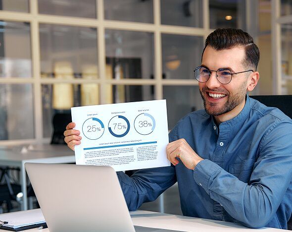 Marketing strategist holding up a performance report