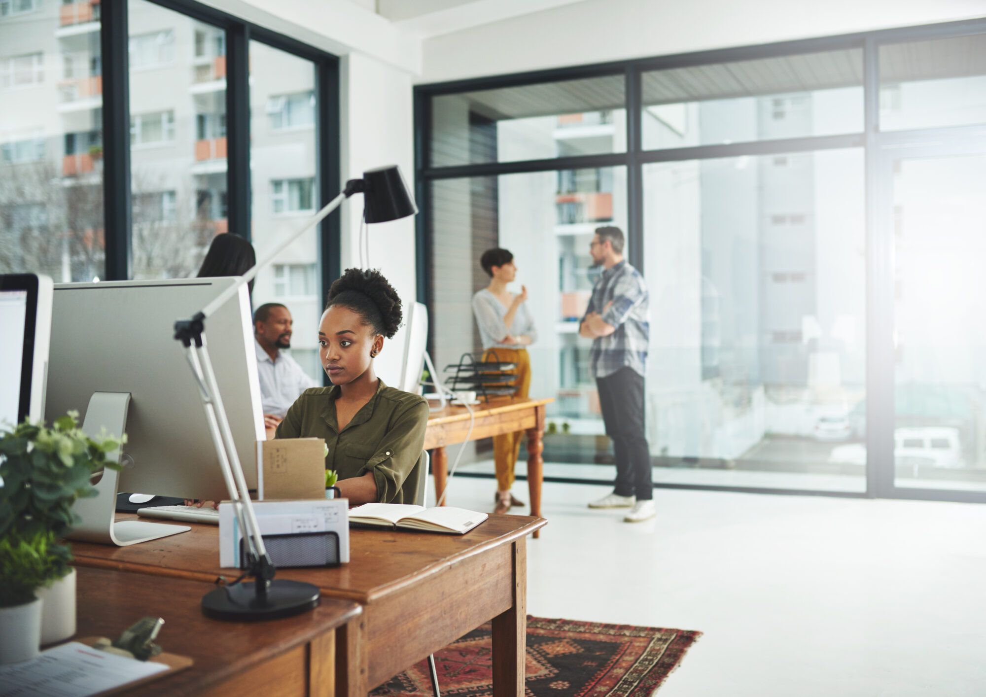Marketing specialist working at a desk in an open office