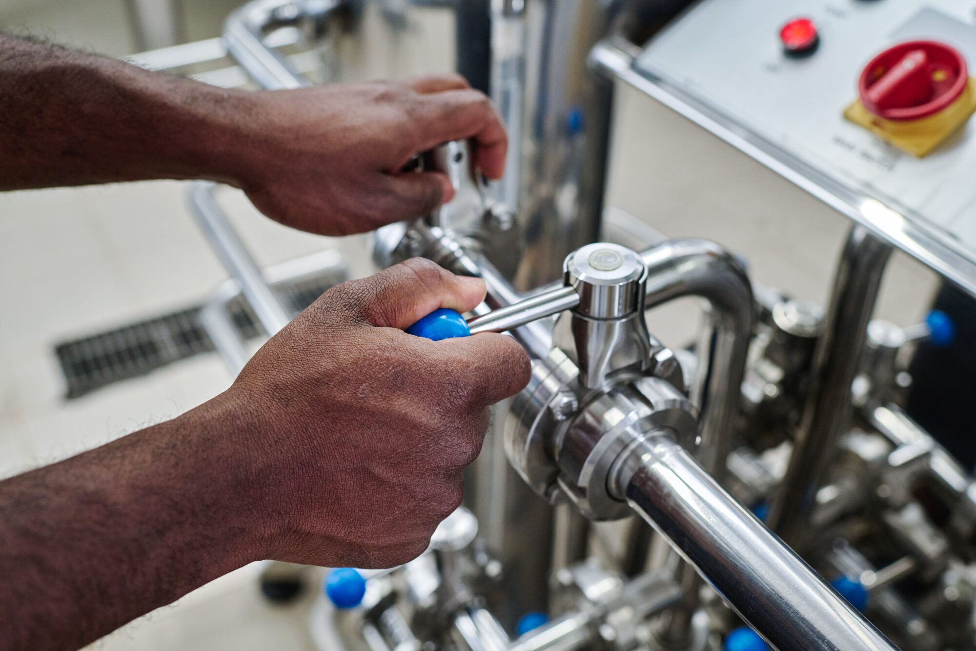 Plumber turning a valve on a commercial piping system