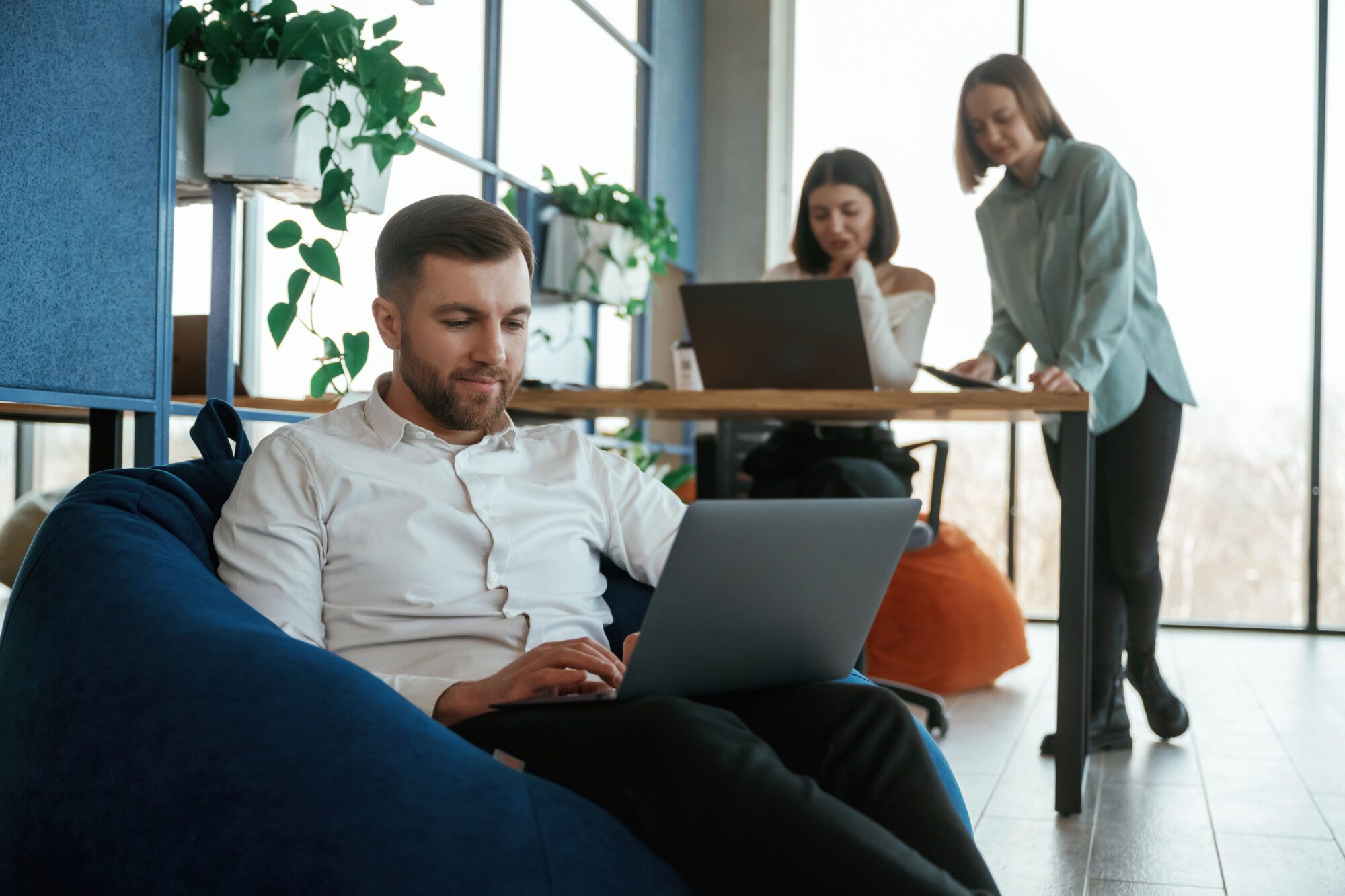 Marketing team working on laptops in a bright office